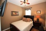 Queen bedroom with wall mounted TV